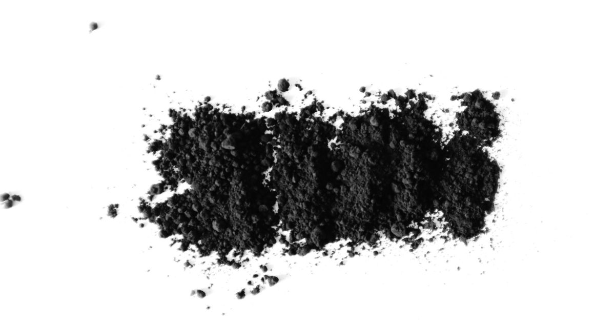A pile of activated charcoal powder on a white background.