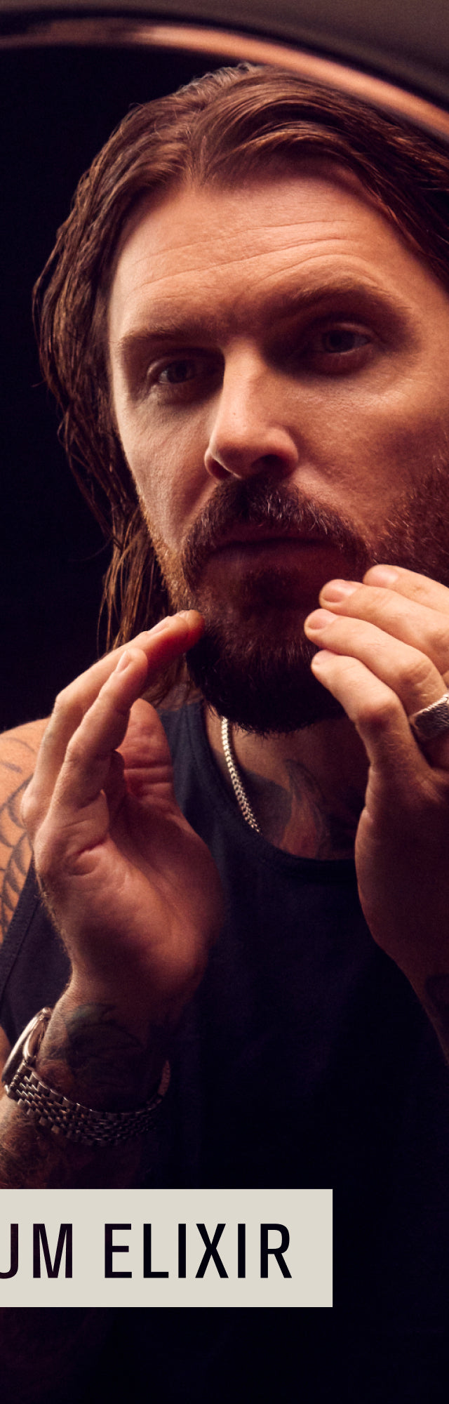 Man applying beard oil in front of a mirror with the text 'No1 PREMIUM ELIXIR' below