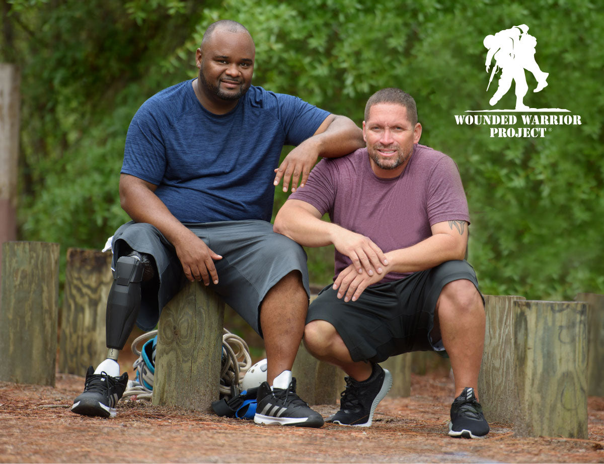 Two men, one with a prosthetic leg, promoting Wounded Warrior Project.