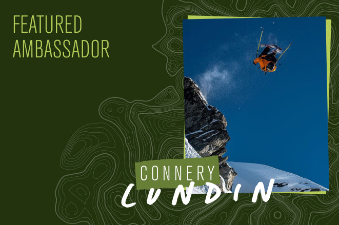 Featured Ambassador Connery Lundin skiing off a cliff with text overlay 'FEATURED AMBASSADOR' and 'CONNERY LUNDIN'