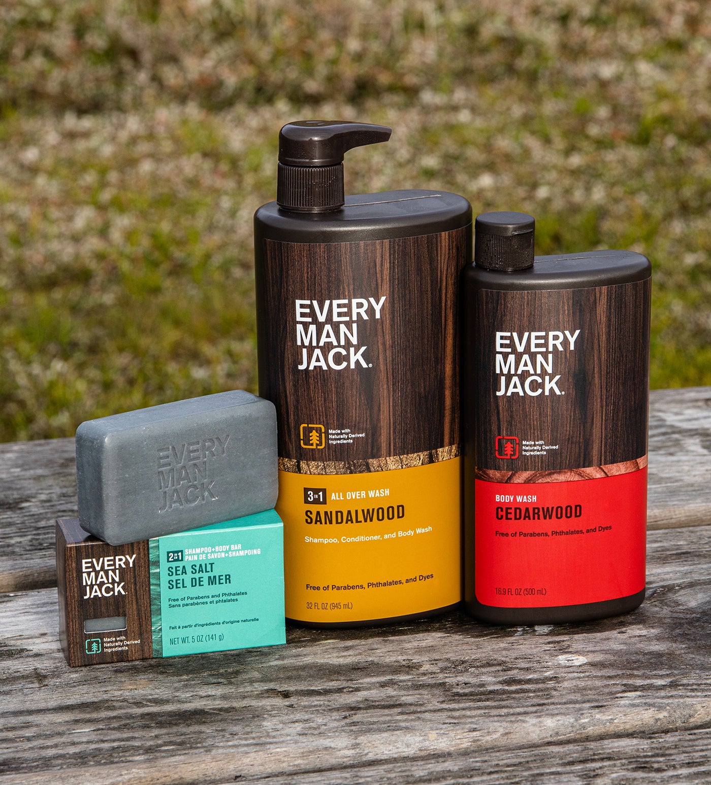 Every Man Jack shampoo and body wash products in Sandalwood and Cedarwood scents on a wooden surface.