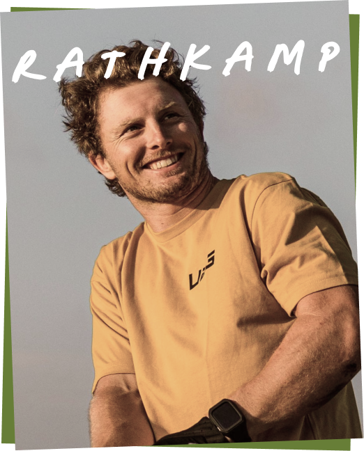 Smiling man wearing a tan shirt with 'VJS' logo, name 'RATHKAMP' displayed above.