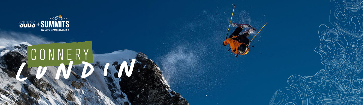 Connery Lundin skiing in the mountains with snow and blue sky, featuring text 'Connery Lundin' and logo 'Suds + Summits'.