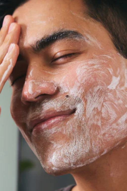 Man washing face and smiling