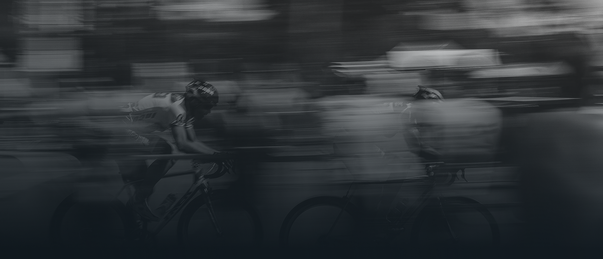 Cyclist riding a road bike through a motion-blurred race scene with a dark blue gradient overlay