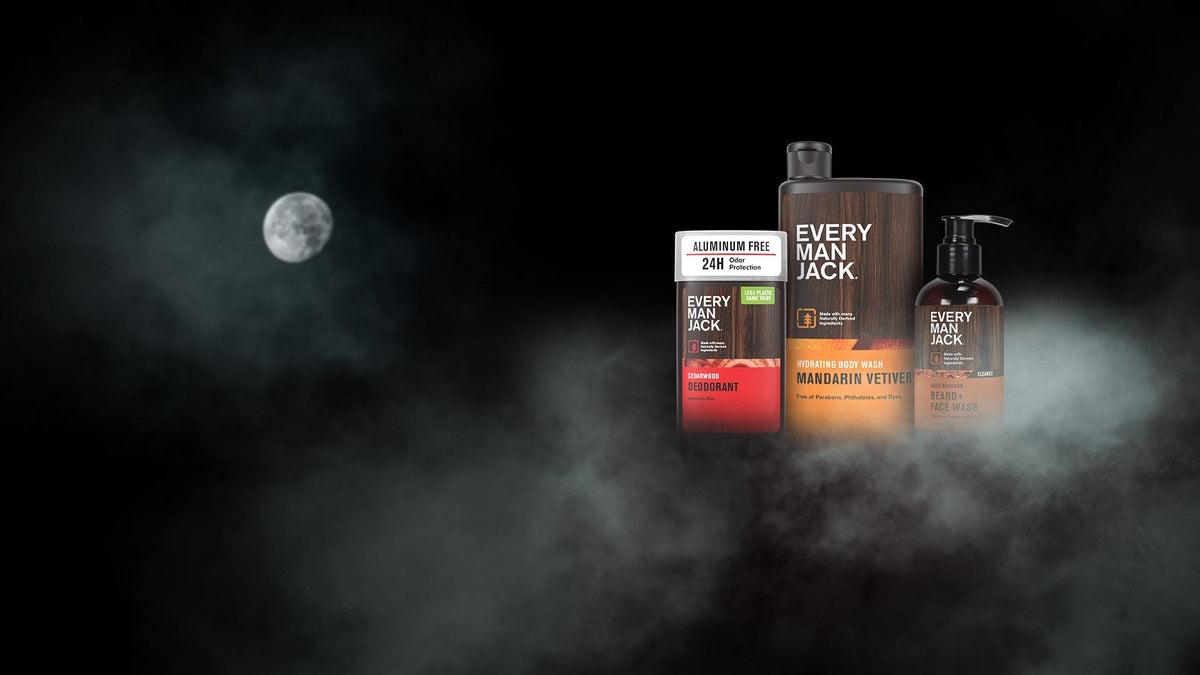 Three Every Man Jack grooming products displayed in a foggy Halloween scene with a full moon and dark background