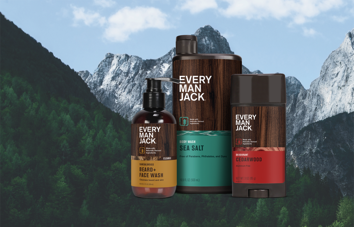 Front view of three products: Sandalwood Beard and Face Wash, Sea Salt body wash, Cedarwood deodorant on mountain backdrop