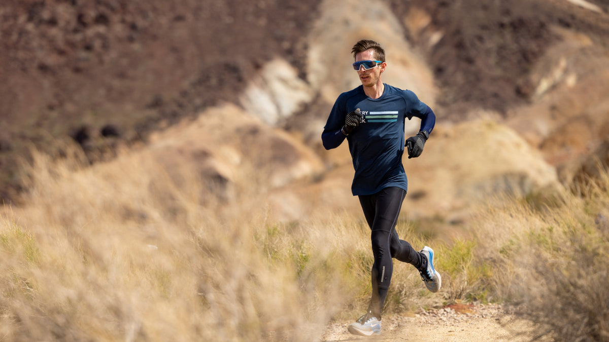 Athlete running on a trail in a natural landscape