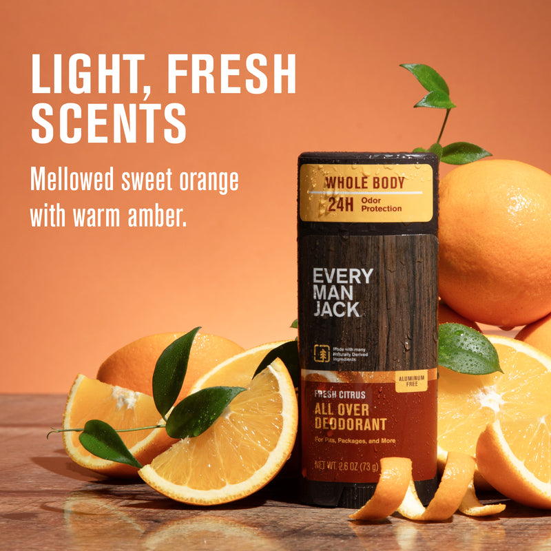 Every Man Jack Fresh Citrus All Over Deodorant stick with orange slices and leaves on an orange background