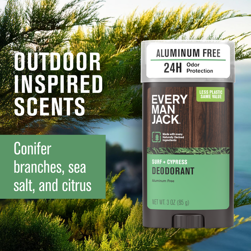 Every Man Jack Surf + Cypress deodorant stick with wood-grain label over coastal conifer background.