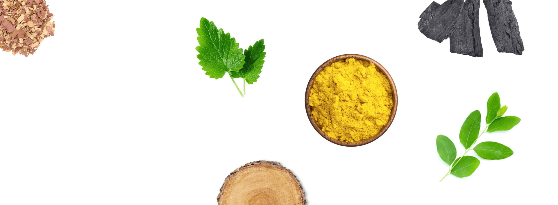 Natural ingredients including leaves, wood, and yellow powder on a white background.
