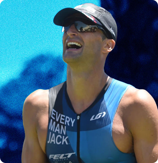 Smiling athlete in a triathlon suit with 'EVERY MAN JACK' logo