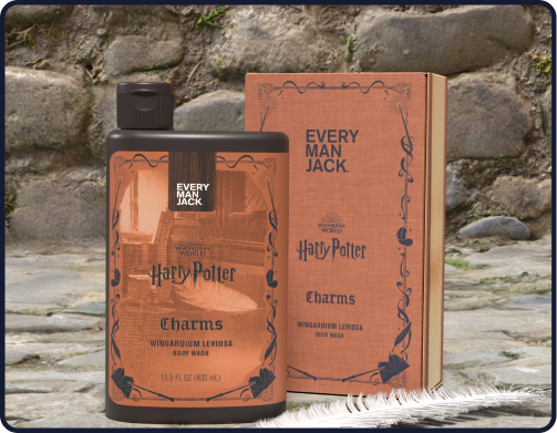 Front view of Every Man Jack Harry Potter Charms Wingardium Leviosa body wash bottle and box showing label and quill on stone background