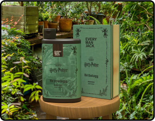 Front view of Herbology Mandrake body wash bottle and box showcasing green Harry Potter packaging on stool in garden