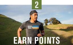 A man running outdoors wearing a shirt with 'EVERY MAN JACK' and colorful stripes, with the text 'EARN POINTS' below.