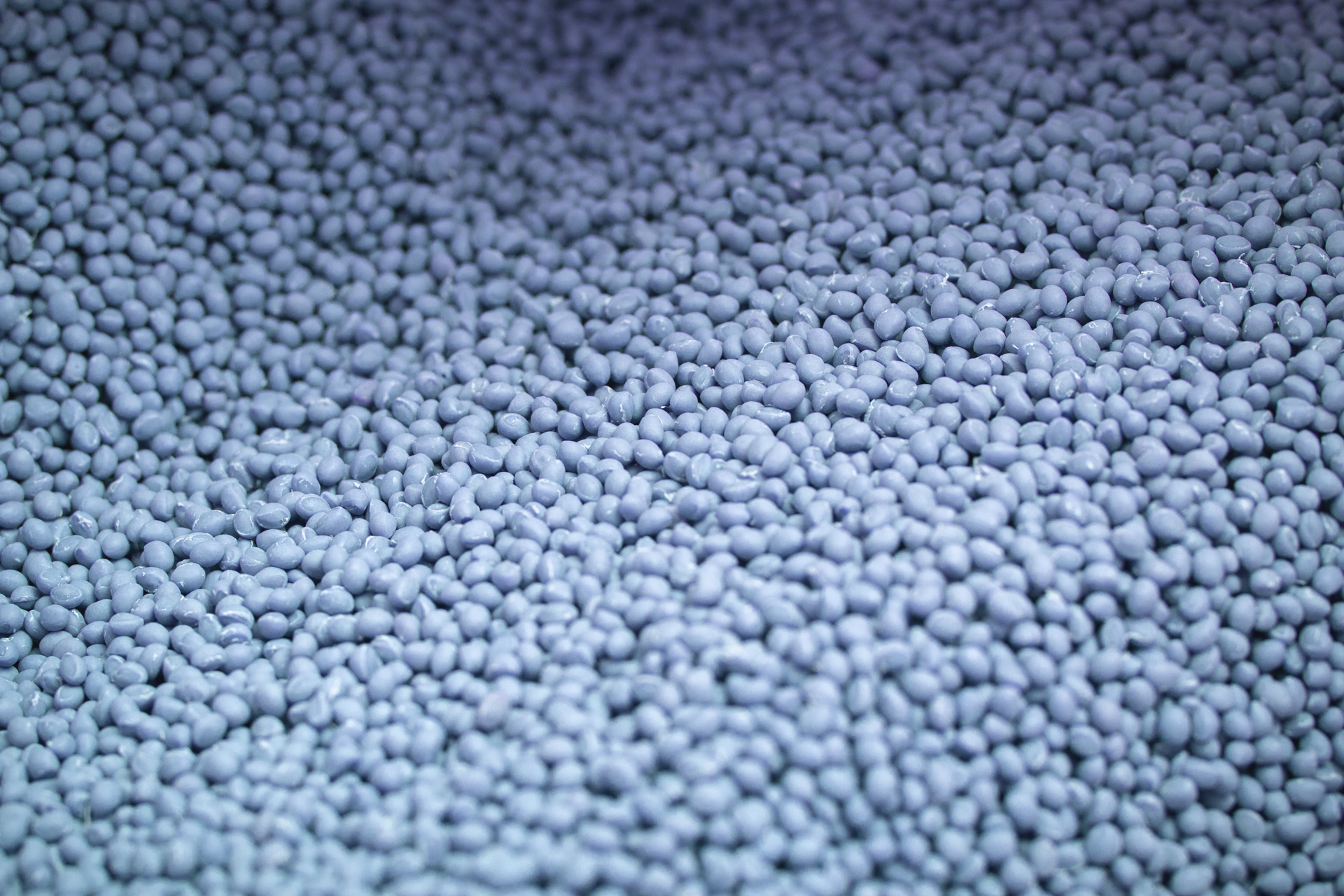 Close-up of blue post-consumer recycled plastic granules