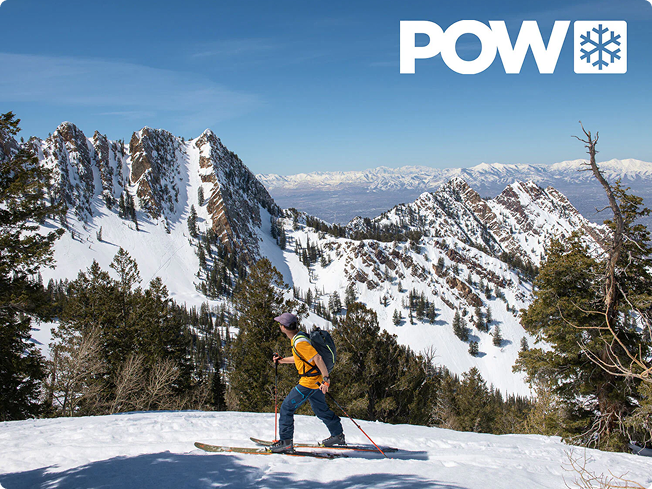 Skier ascending a snowy mountain ridge with POW logo overlaid in the top-right and snow-covered peaks in the background
