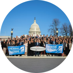 Surfrider volunteers gathered on the U.S. Capitol steps holding banners reading “The Ocean Friends” and a surfboard